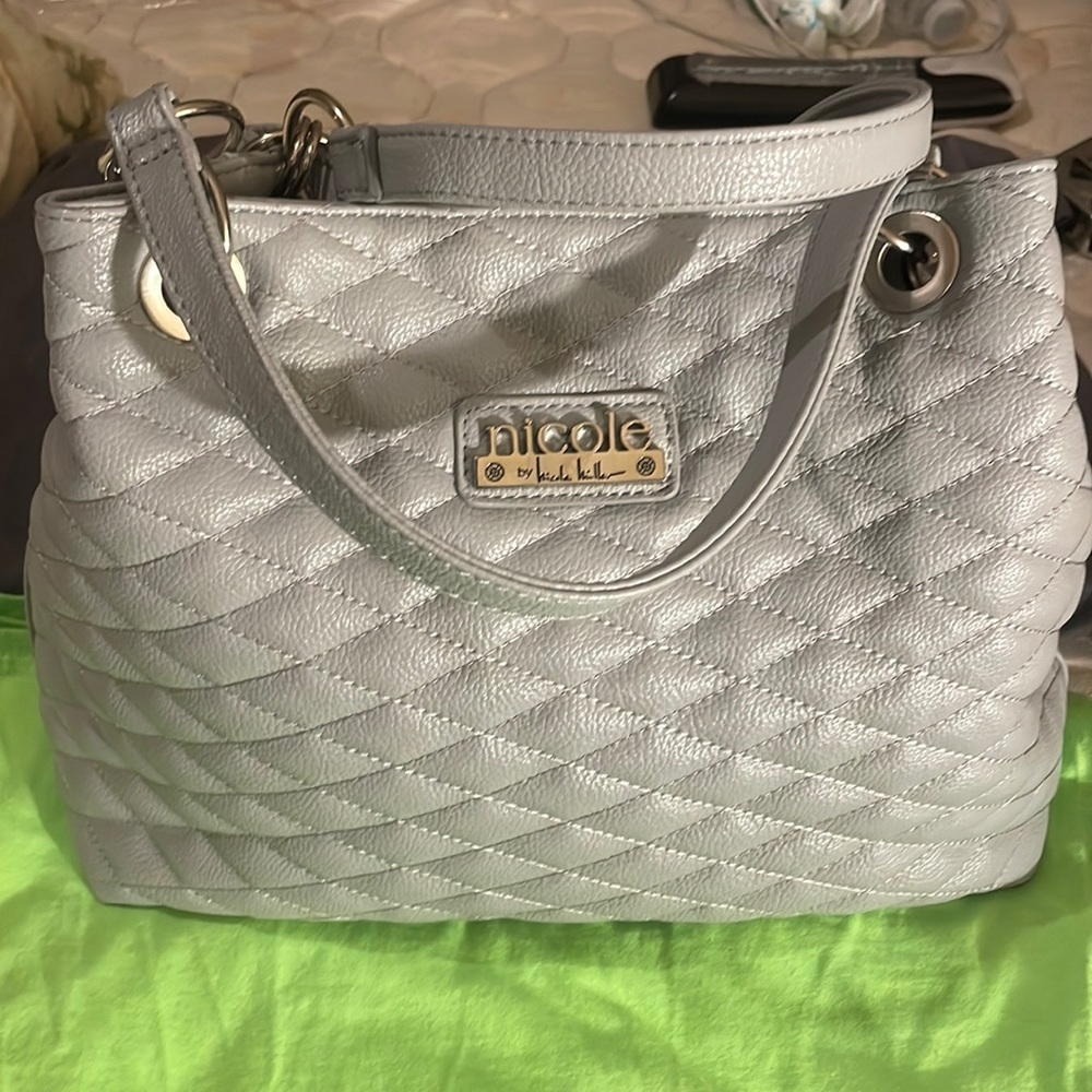 New. Quilted, no leather lady’s handbag. 13” L, 4”W, 10 1/4”H. Unused.